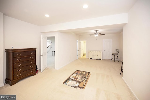 carpeted spare room with ceiling fan