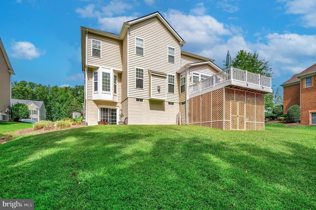 back of property with a deck and a lawn