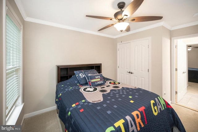 bedroom with ornamental molding, a closet, ceiling fan, and carpet