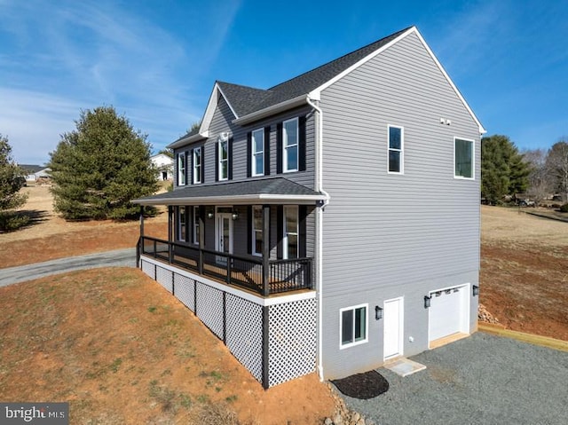 exterior space with a garage and covered porch