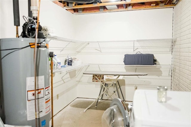 utility room featuring gas water heater