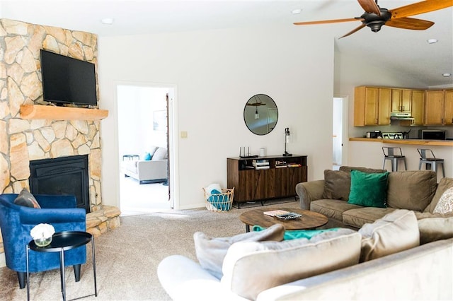 living area with carpet, a fireplace, a ceiling fan, high vaulted ceiling, and baseboards