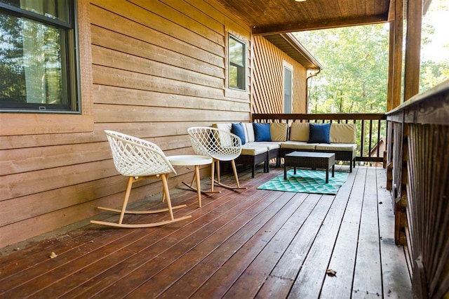 wooden terrace featuring an outdoor living space