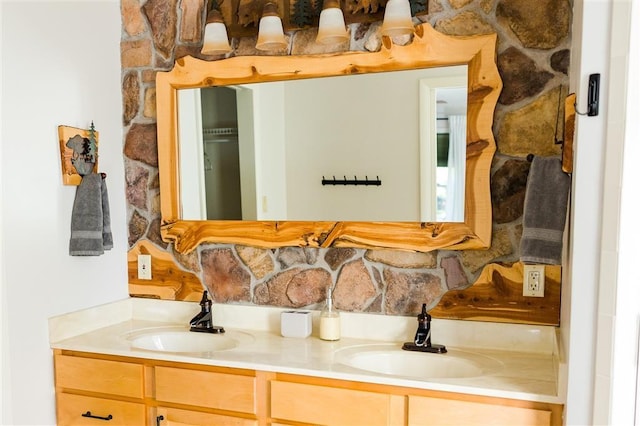 bathroom with double vanity, tasteful backsplash, and a sink