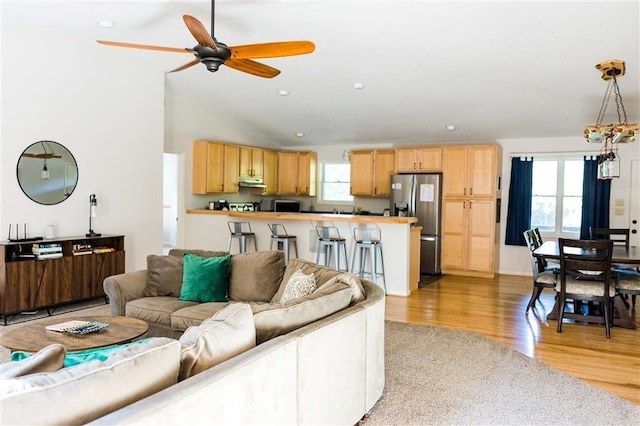 living room featuring high vaulted ceiling, recessed lighting, ceiling fan, and light wood-style flooring