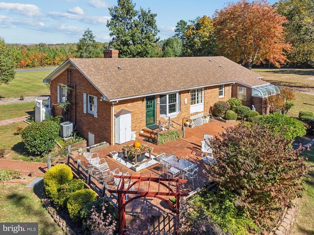 back of property with central AC, an outdoor structure, and a patio