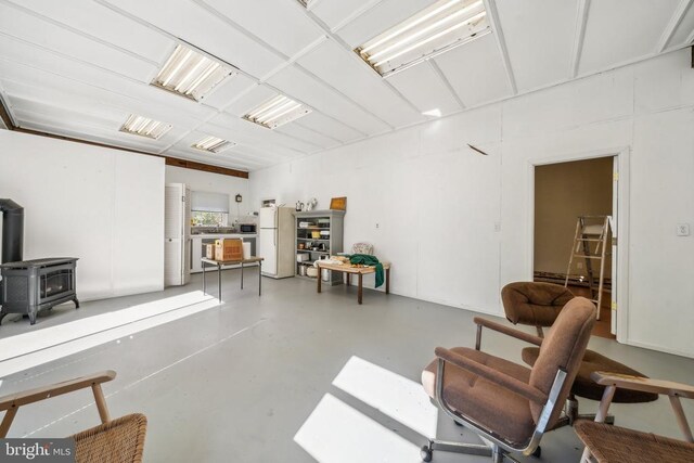 interior space featuring a wood stove and concrete floors