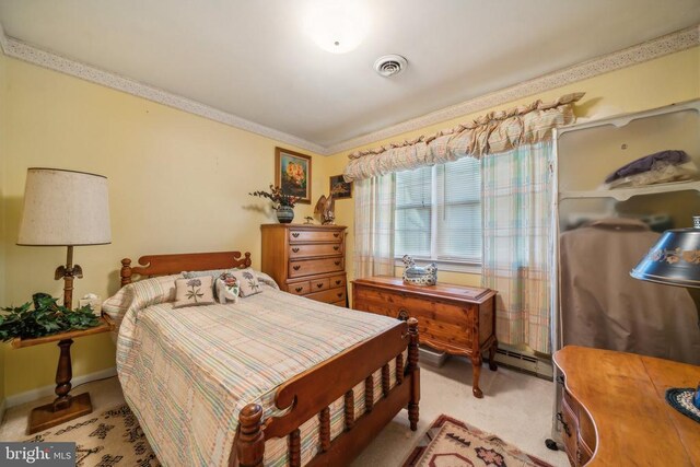 carpeted bedroom with baseboard heating and crown molding