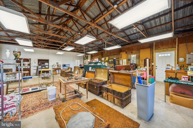 miscellaneous room with vaulted ceiling and a workshop area