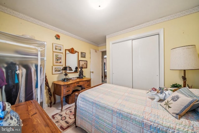 bedroom with crown molding and a closet