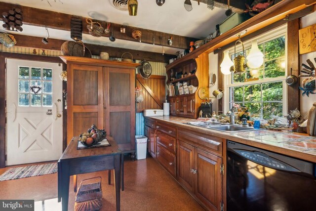 kitchen featuring sink, tile countertops, hanging light fixtures, and dishwasher