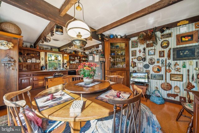 dining room featuring beam ceiling