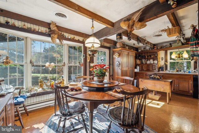 dining area with beam ceiling