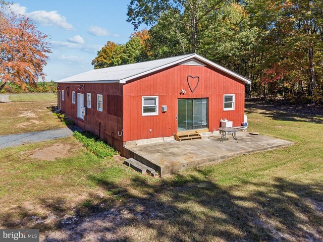 view of outbuilding featuring a yard