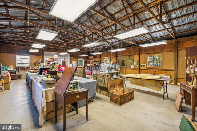 miscellaneous room with vaulted ceiling and a workshop area