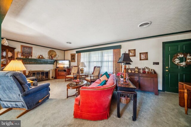 carpeted living room with ornamental molding and a brick fireplace