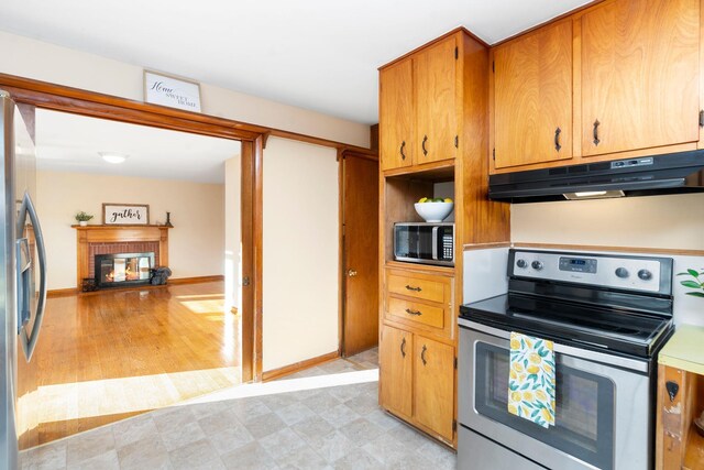 kitchen featuring stainless steel appliances and a fireplace