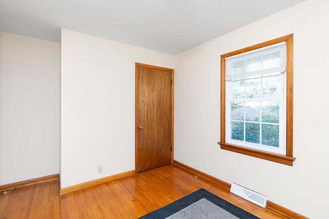 empty room with light hardwood / wood-style flooring