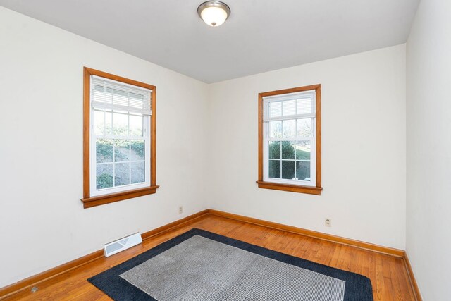 unfurnished room featuring hardwood / wood-style floors