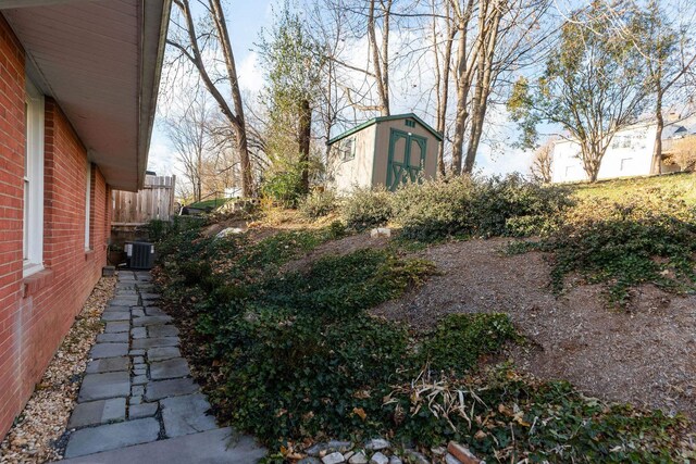 view of yard with a shed and central AC