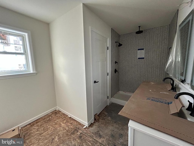 bathroom featuring vanity and tiled shower