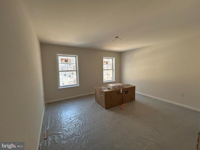 spare room featuring concrete flooring