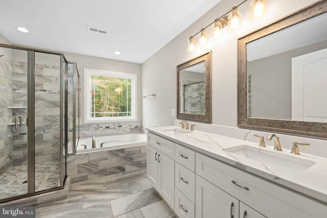 kitchen featuring sink, white cabinetry, hanging light fixtures, stainless steel appliances, and a kitchen island with sink