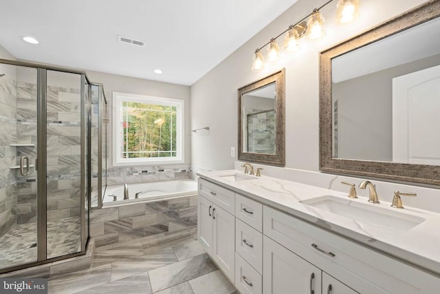 bathroom with independent shower and bath and vanity