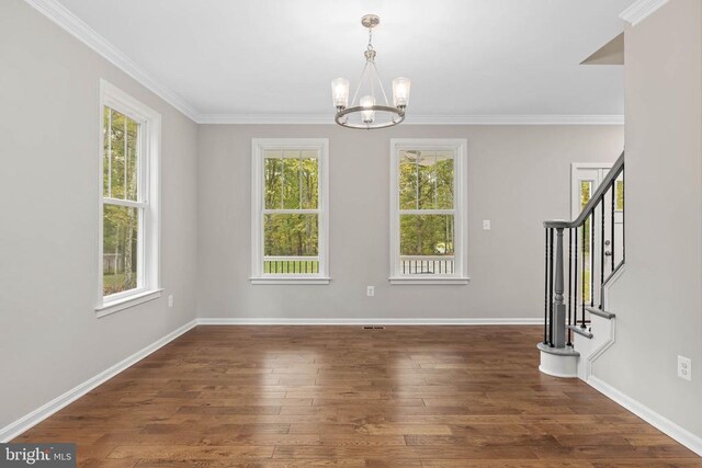 interior space featuring crown molding, dark wood-type flooring, and a chandelier