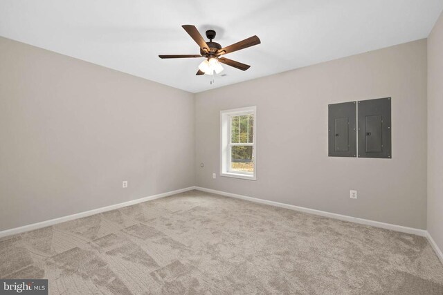 carpeted empty room featuring electric panel and ceiling fan