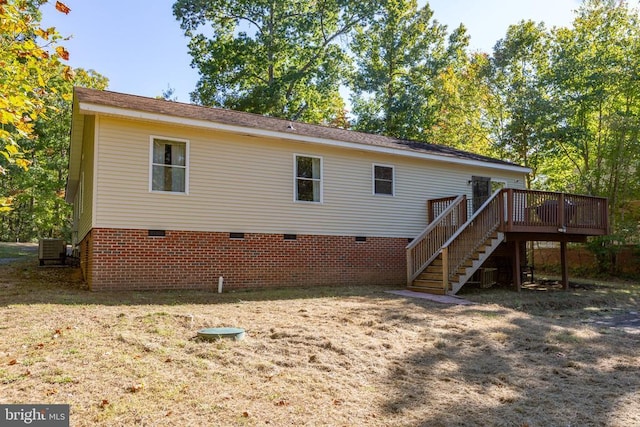 rear view of house with a wooden deck and central AC unit