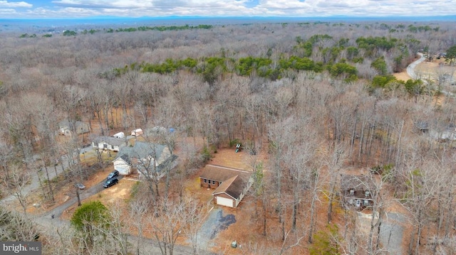 birds eye view of property with a forest view