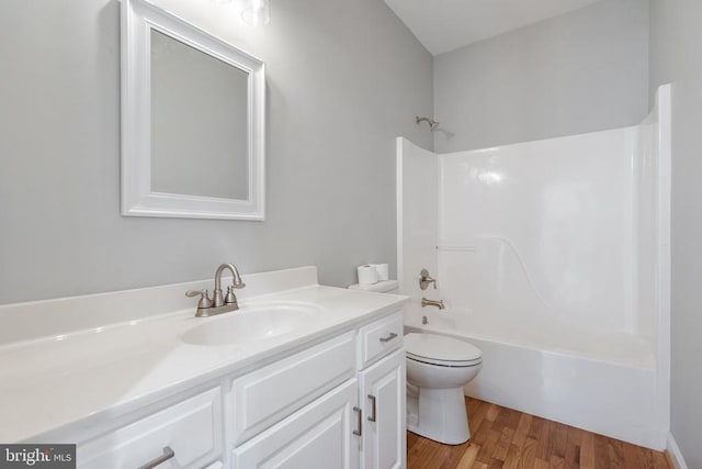 full bath with vanity, bathtub / shower combination, toilet, and wood finished floors