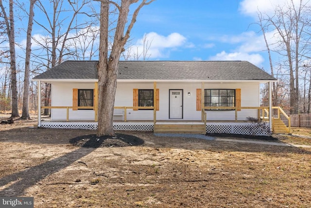 view of front of house featuring covered porch and roof with shingles