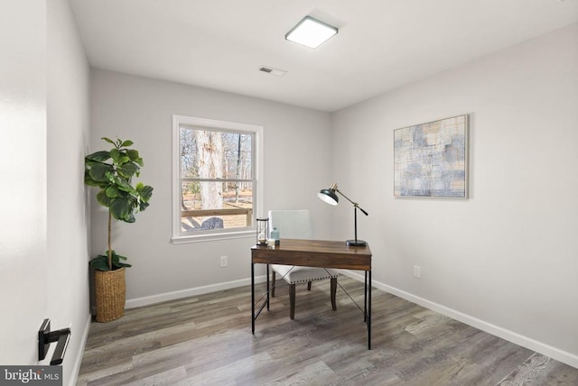 office space with baseboards and wood finished floors