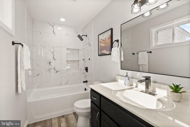 full bath featuring vanity, shower / tub combination, toilet, and wood finished floors