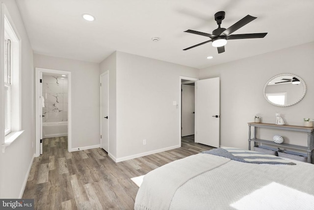 bedroom featuring recessed lighting, connected bathroom, baseboards, and wood finished floors