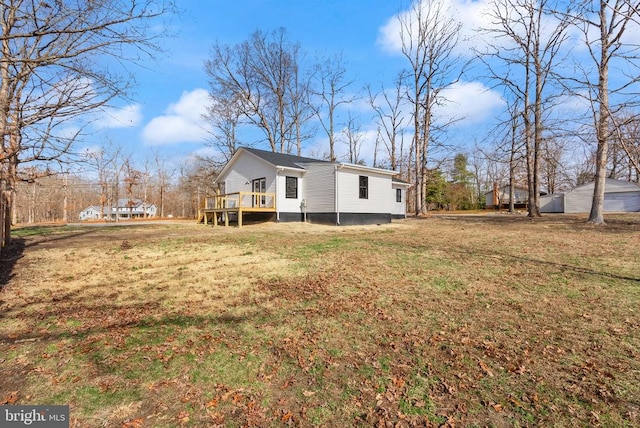 exterior space with a yard and a wooden deck