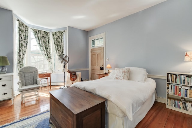 bedroom with dark wood-type flooring