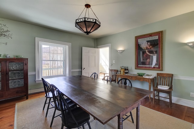 dining area with baseboard heating and wood-type flooring