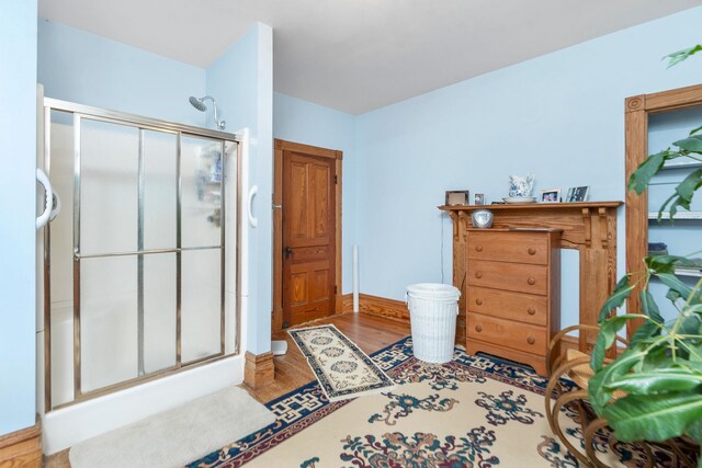 bathroom featuring a shower with door