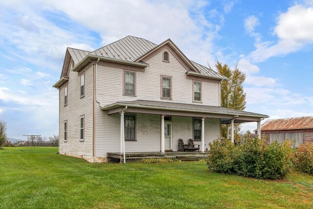 view of front of home with a porch and a front lawn