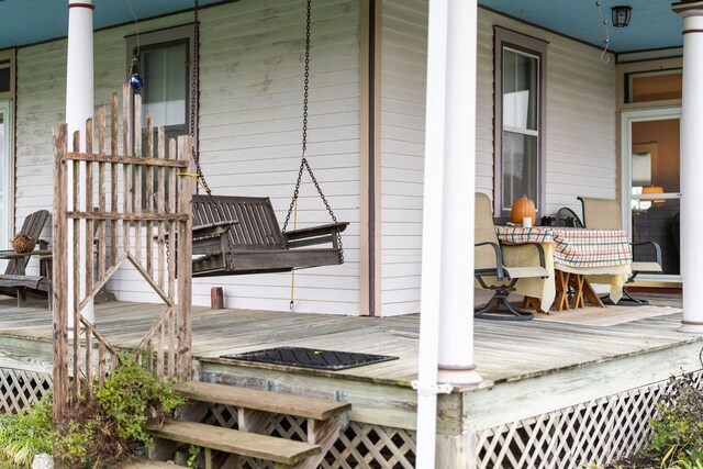 wooden terrace with a porch