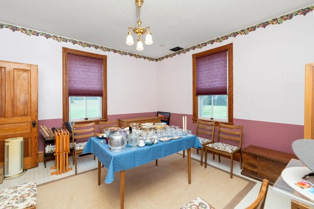 bedroom featuring multiple windows and a chandelier