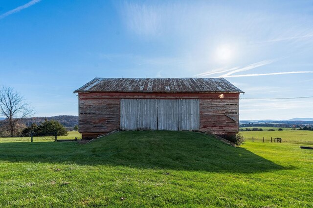 view of outbuilding with a yard and a rural view