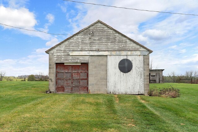 view of outbuilding with a lawn