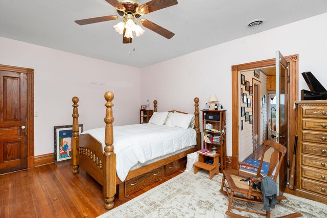 bedroom with wood-type flooring and ceiling fan