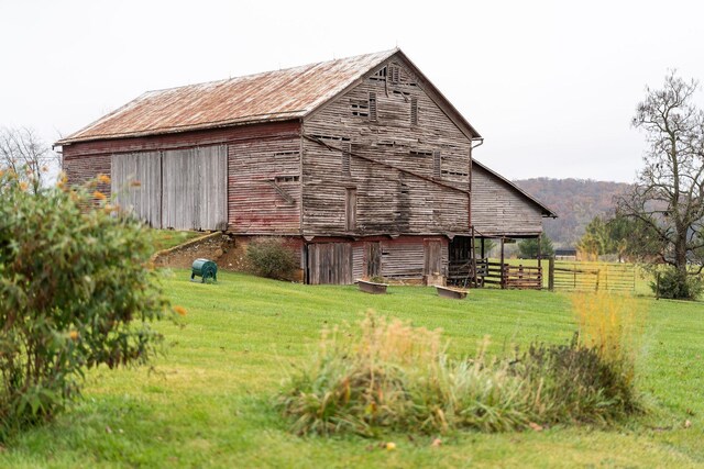 view of outbuilding featuring a lawn