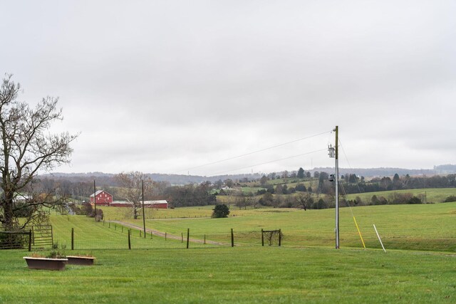 view of community featuring a rural view and a lawn