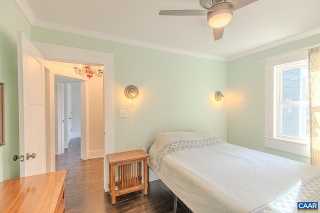 bedroom with dark wood-type flooring, ornamental molding, baseboards, and a ceiling fan